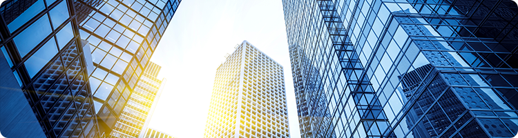 photo of modern glass office building from the ground looking up representing an itential case study on automating load balancers